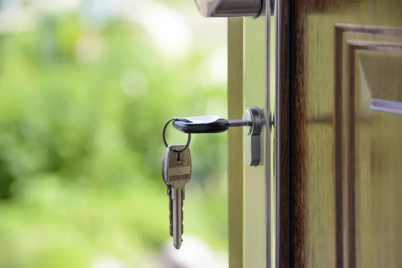 A bunch of keys left hanging in a door lock